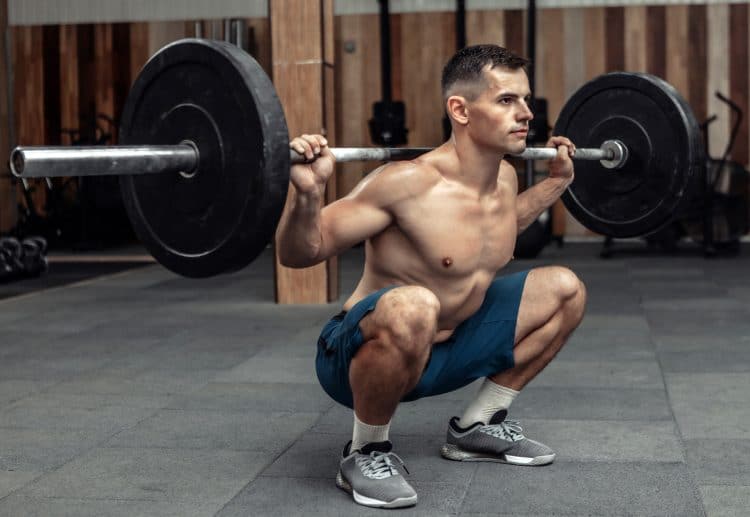 Bodybuilder Doing Squats With A Barbell